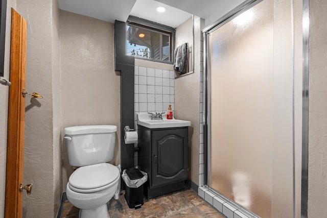 11411 Johnson Cir, Bloomington, MN 55437 - bathroom with a stall shower, toilet, vanity, stone finish flooring, and recessed lighting
