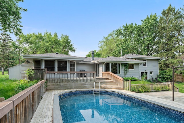 11411 Johnson Cir, Bloomington, MN 55437 - rear view of house with a wooden deck, an outdoor pool, a sunroom, and a shingled roof