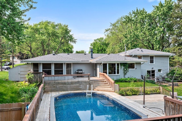11411 Johnson Cir, Bloomington, MN 55437 - rear view of property featuring a wooden deck, a sunroom, an outdoor pool, and roof with shingles