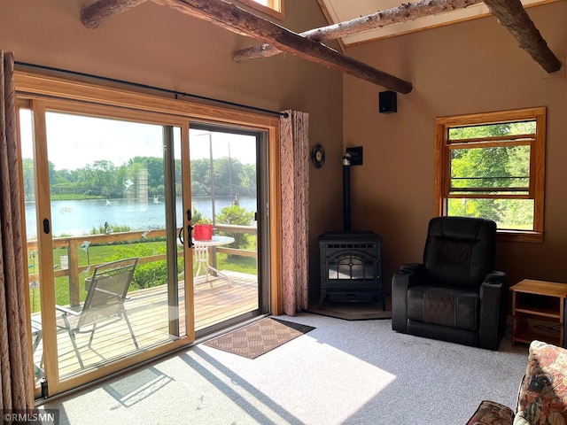 43639 351st Ln, Aitkin Twp, MN 56431 - doorway to outside featuring a water view, carpet flooring, healthy amount of natural light, and a wood stove