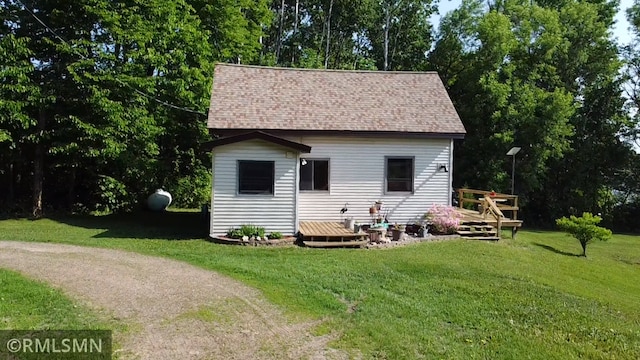 43639 351st Ln, Aitkin Twp, MN 56431 - rear view of house with a wooden deck, a yard, and a shingled roof
