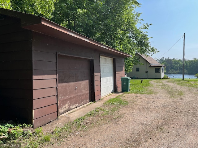 43639 351st Ln, Aitkin Twp, MN 56431 - garage with driveway and a water view