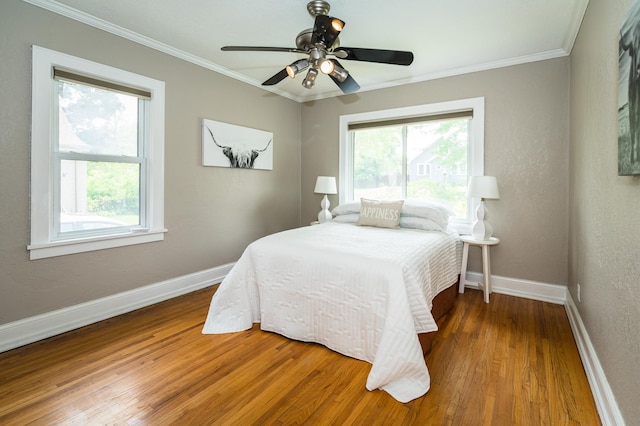 971 Mclean Ave, Saint Paul, MN 55106 - bedroom with multiple windows, wood finished floors, baseboards, ornamental molding, and ceiling fan