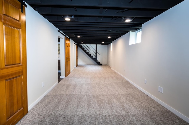 971 Mclean Ave, Saint Paul, MN 55106 - hallway featuring light carpet, stairway, baseboards, and a barn door