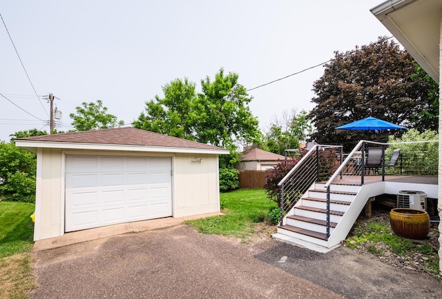971 Mclean Ave, Saint Paul, MN 55106 - detached garage featuring asphalt driveway and central AC unit