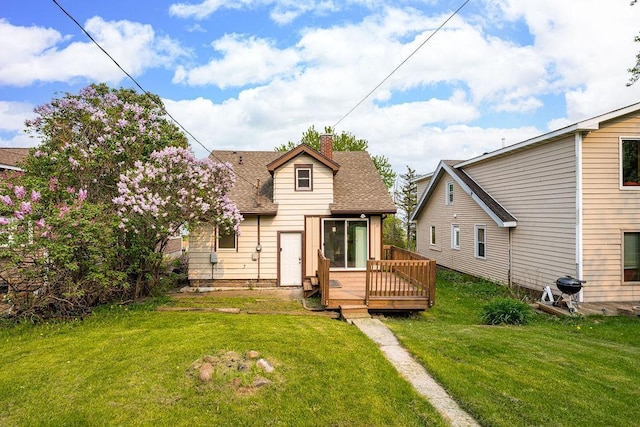 627 Skyline Pkwy, Duluth, MN 55805 - back of house with a chimney, a deck, a shingled roof, and a lawn