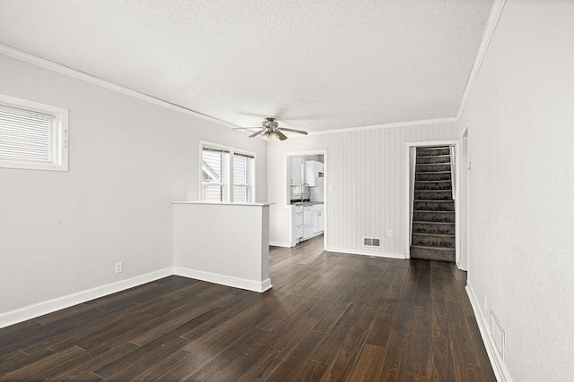 627 Skyline Pkwy, Duluth, MN 55805 - spare room with crown molding, a textured ceiling, a ceiling fan, baseboards, and stairs