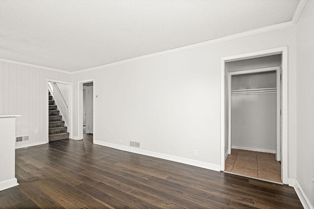 627 Skyline Pkwy, Duluth, MN 55805 - unfurnished living room featuring ornamental molding, stairway, dark wood-style flooring, a textured ceiling, and baseboards