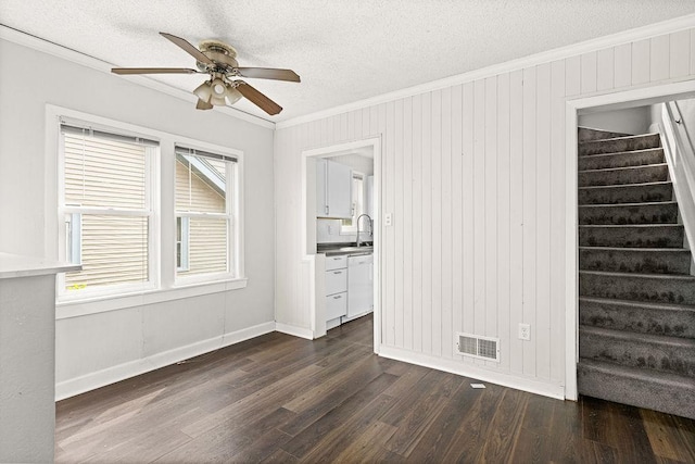 627 Skyline Pkwy, Duluth, MN 55805 - empty room featuring crown molding, ceiling fan, stairway, dark wood-style flooring, and a textured ceiling
