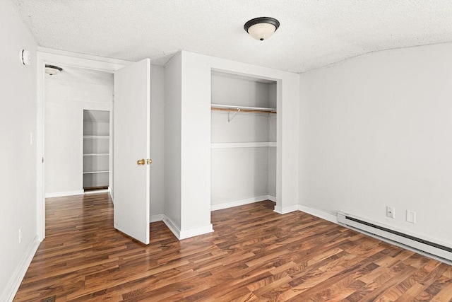 627 Skyline Pkwy, Duluth, MN 55805 - unfurnished bedroom featuring a baseboard radiator, a closet, wood finished floors, a textured ceiling, and baseboards