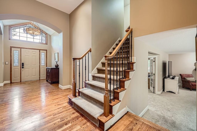9025 Mcguffey Rd, Eden Prairie, MN 55347 - foyer featuring arched walkways, high vaulted ceiling, plenty of natural light, and stairs