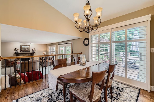 9025 Mcguffey Rd, Eden Prairie, MN 55347 - dining space with a chandelier, wood finished floors, and vaulted ceiling
