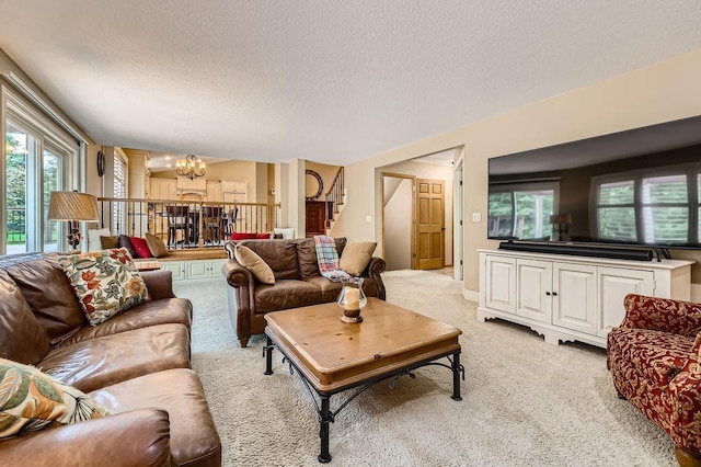 9025 Mcguffey Rd, Eden Prairie, MN 55347 - living area featuring a chandelier, light carpet, a textured ceiling, and stairs