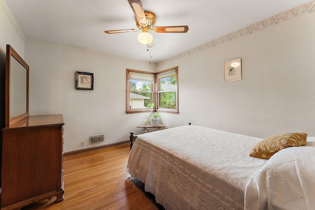 2142 Cottage Ave E, Saint Paul, MN 55119 - bedroom with light wood-style flooring, baseboards, and a ceiling fan