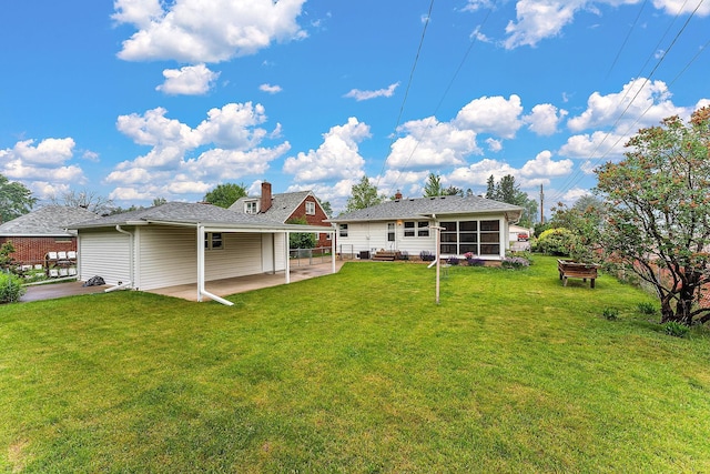 2142 Cottage Ave E, Saint Paul, MN 55119 - back of property with a patio area, a lawn, and a sunroom