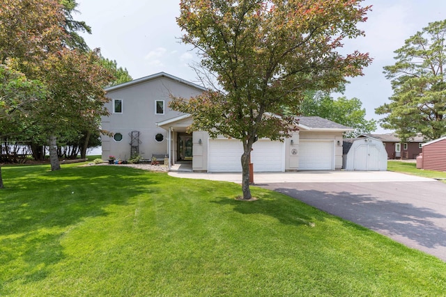 17159 Stalker Lake Rd, Battle Lake, MN 56515 - view of front of house with a front lawn, driveway, a garage, and stucco siding