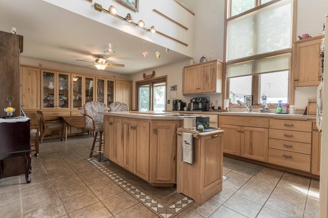 17159 Stalker Lake Rd, Battle Lake, MN 56515 - kitchen featuring a center island, ceiling fan, a sink, light countertops, and light brown cabinetry