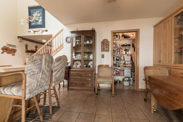 17159 Stalker Lake Rd, Battle Lake, MN 56515 - dining room with dark tile patterned flooring and stairs
