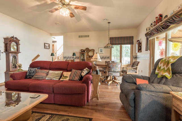 17159 Stalker Lake Rd, Battle Lake, MN 56515 - living area with wood finished floors, a ceiling fan, and stairway