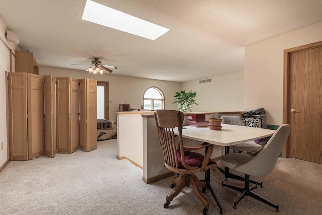 17159 Stalker Lake Rd, Battle Lake, MN 56515 - dining room featuring light carpet, a skylight, a ceiling fan, and baseboards