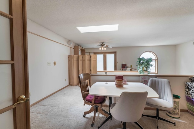 17159 Stalker Lake Rd, Battle Lake, MN 56515 - dining space featuring light carpet, a skylight, baseboards, and a textured ceiling