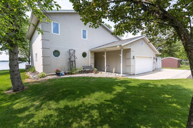 17159 Stalker Lake Rd, Battle Lake, MN 56515 - view of front of home featuring stucco siding, a front yard, concrete driveway, and a garage