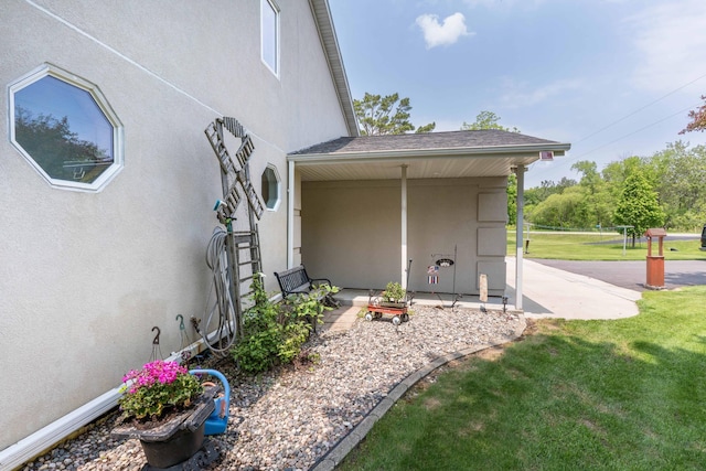 17159 Stalker Lake Rd, Battle Lake, MN 56515 - view of side of home featuring a yard, stucco siding, and a patio area