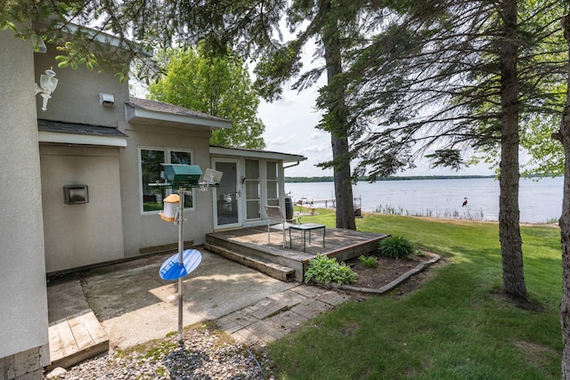 17159 Stalker Lake Rd, Battle Lake, MN 56515 - view of grassy yard featuring a deck with water view and a sunroom