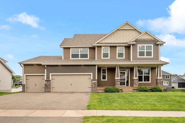 1840 Old Mill Ct, Centerville, MN 55038 - craftsman-style house featuring asphalt driveway, stone siding, a front lawn, covered porch, and roof with shingles