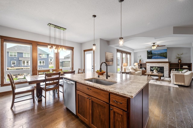 1840 Old Mill Ct, Centerville, MN 55038 - kitchen featuring stainless steel dishwasher, a sink, dark wood-style flooring, a ceiling fan, and a stone fireplace