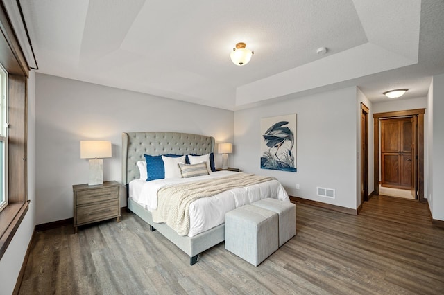 1840 Old Mill Ct, Centerville, MN 55038 - bedroom featuring a tray ceiling, wood finished floors, and baseboards