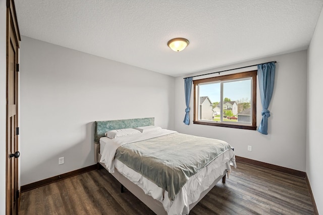 1840 Old Mill Ct, Centerville, MN 55038 - bedroom with dark wood-type flooring, baseboards, and a textured ceiling