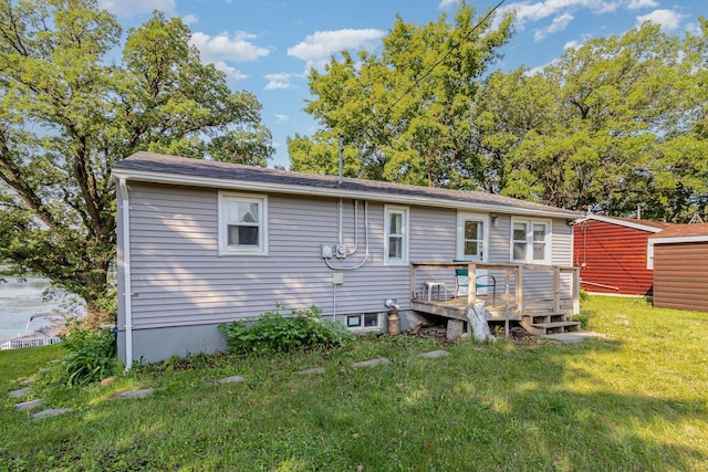 6269 85th St NW, Corinna Twp, MN 55358 - rear view of house with a wooden deck and a lawn