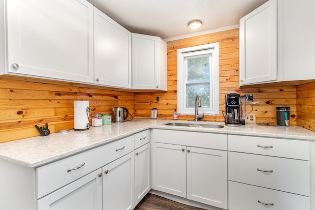 6269 85th St NW, Corinna Twp, MN 55358 - kitchen featuring a sink, white cabinetry, wooden walls, light stone counters, and dark wood-style flooring