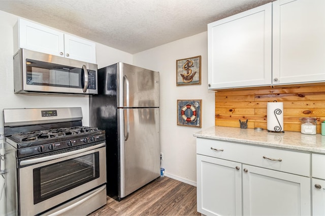 6269 85th St NW, Corinna Twp, MN 55358 - kitchen featuring appliances with stainless steel finishes, wood finished floors, baseboards, a textured ceiling, and white cabinets