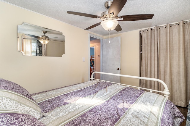 6269 85th St NW, Corinna Twp, MN 55358 - bedroom with a textured ceiling and ceiling fan