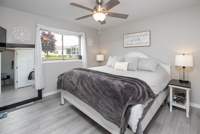 3900 Orchardview Ln NW, Rochester, MN 55901 - bedroom with light wood-style flooring, baseboards, and a ceiling fan