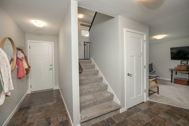 3900 Orchardview Ln NW, Rochester, MN 55901 - entryway with a textured ceiling, baseboards, stone finish floors, and stairway