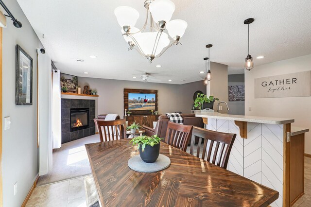 1704 Talon Trl, Eagan, MN 55122 - dining area featuring a fireplace, a ceiling fan, baseboards, and recessed lighting