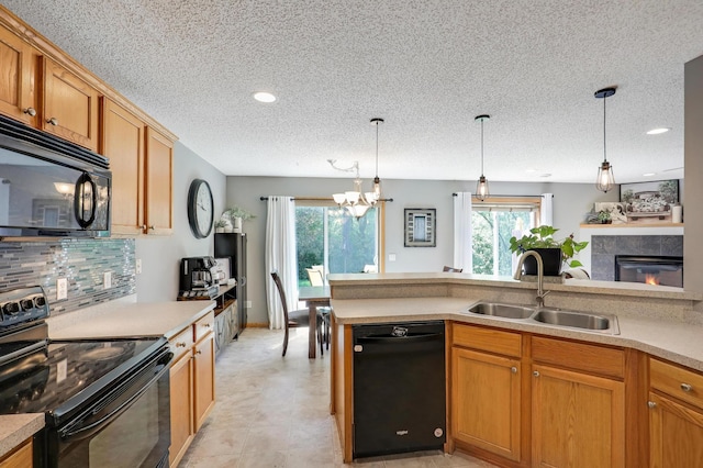 1704 Talon Trl, Eagan, MN 55122 - kitchen with black appliances, a sink, a textured ceiling, healthy amount of natural light, and light countertops