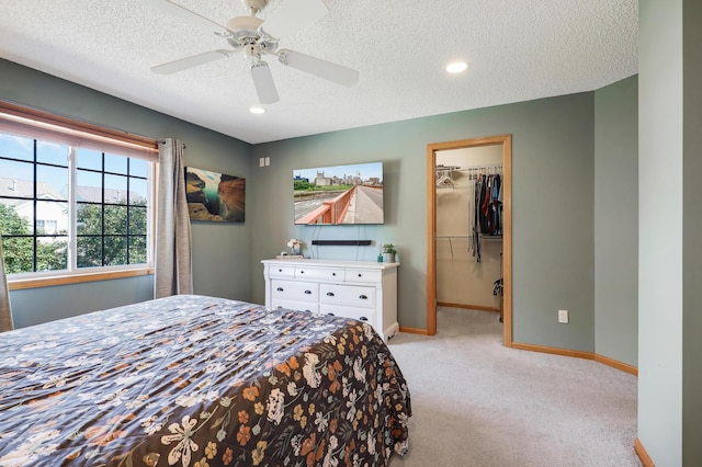 1704 Talon Trl, Eagan, MN 55122 - bedroom with light colored carpet, a spacious closet, baseboards, a textured ceiling, and ceiling fan