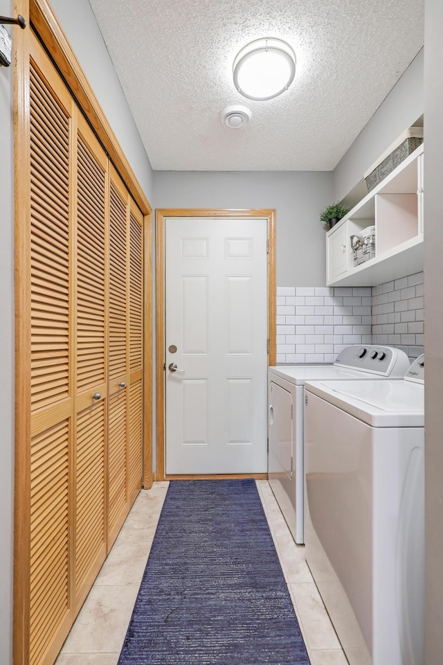 1704 Talon Trl, Eagan, MN 55122 - laundry room featuring washing machine and clothes dryer, a textured ceiling, and light tile patterned floors