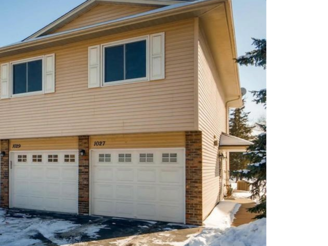 1029 Pond View Ct, Vadnais Heights, MN 55127 - view of snowy exterior featuring brick siding and an attached garage
