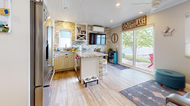 27096 Little Floyd Lake Rd Unit 2, Detroit Twp, MN 56501 - kitchen featuring appliances with stainless steel finishes, a wall mounted air conditioner, light wood-style flooring, recessed lighting, and a peninsula