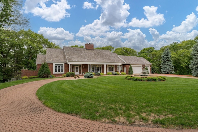 17 Oriole Pl, North Mankato, MN 56003 - ranch-style house with curved driveway, a front yard, a chimney, a garage, and brick siding