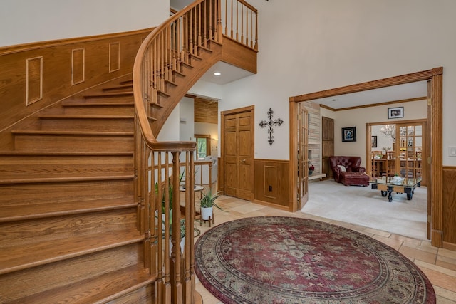 17 Oriole Pl, North Mankato, MN 56003 - staircase with a wainscoted wall, carpet, and a towering ceiling