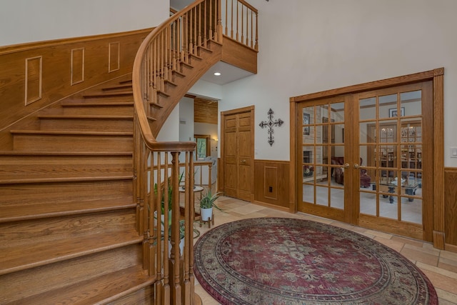 17 Oriole Pl, North Mankato, MN 56003 - foyer with french doors, stairway, a wainscoted wall, and a high ceiling