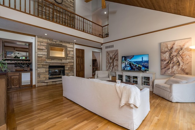 17 Oriole Pl, North Mankato, MN 56003 - living room featuring high vaulted ceiling, a stone fireplace, wood finished floors, and recessed lighting