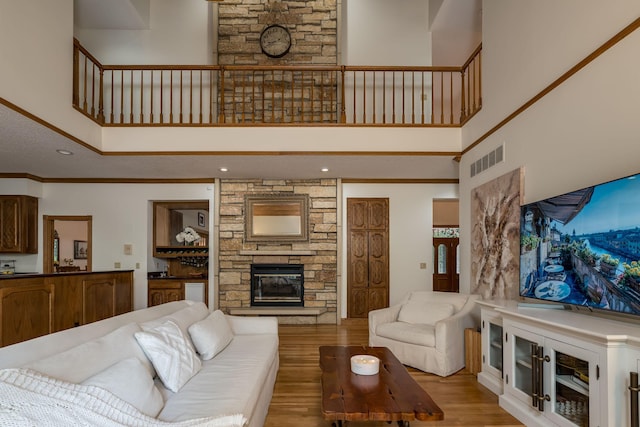 17 Oriole Pl, North Mankato, MN 56003 - living area featuring a stone fireplace, a towering ceiling, and wood finished floors