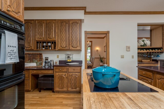 17 Oriole Pl, North Mankato, MN 56003 - kitchen with ornamental molding, black appliances, light wood-style floors, and brown cabinetry